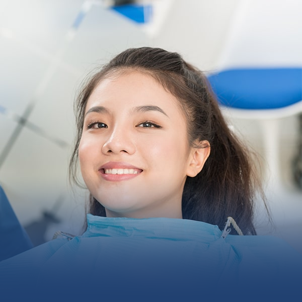 woman smiling in a dentist's chair